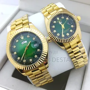 Gold-Toned Rolex Day-Date Watches With Green Dials.