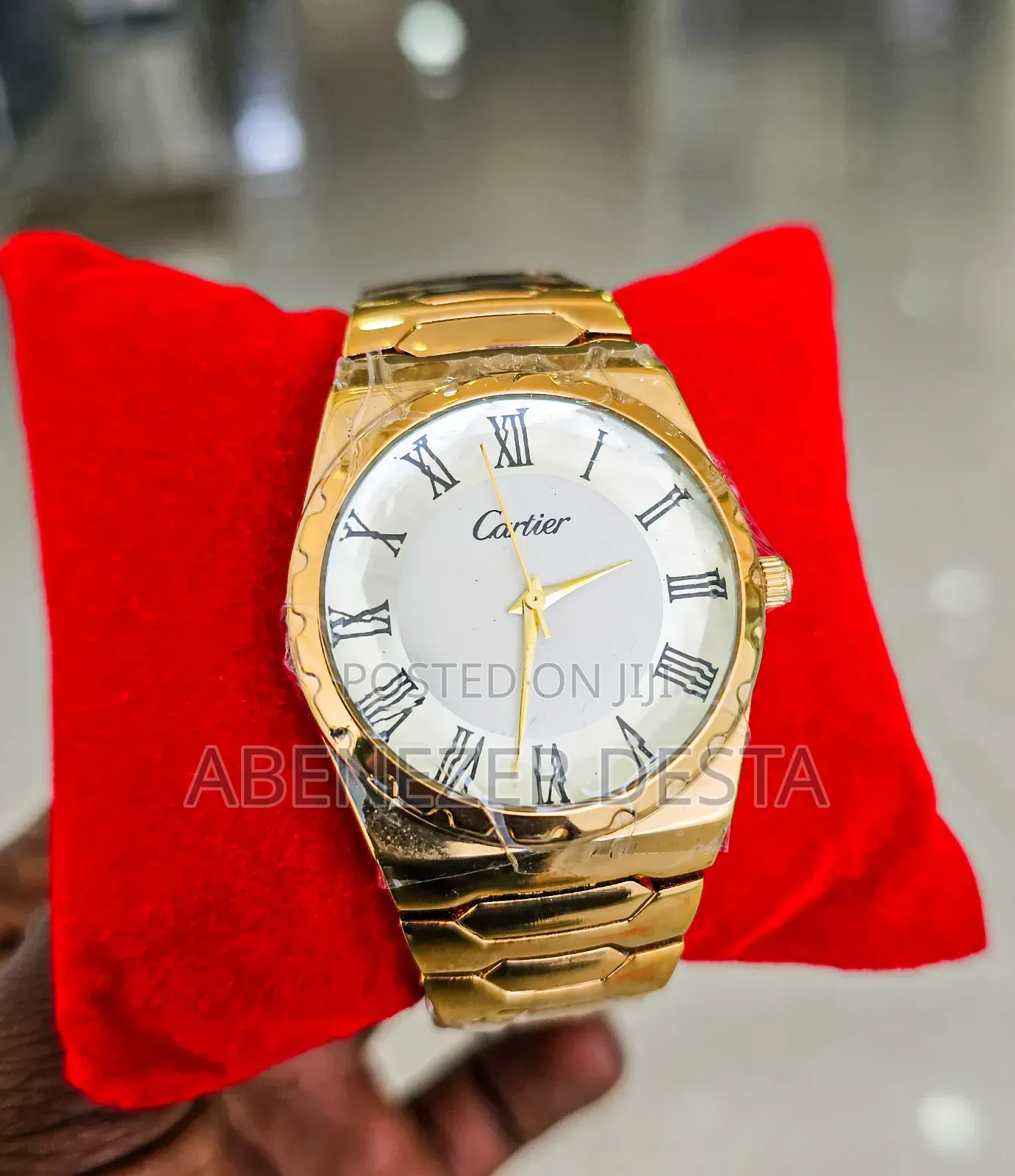 Gold-Colored Wristwatch With a White Dial and Roman Numerals