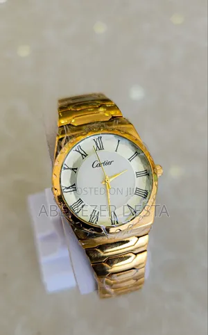 Gold-Colored Wristwatch With a White Dial and Roman Numerals