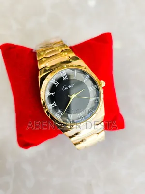 Gold-Tone Watch With a Black Face and Roman Numerals.