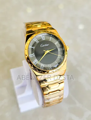 Gold-Tone Watch With a Black Face and Roman Numerals.