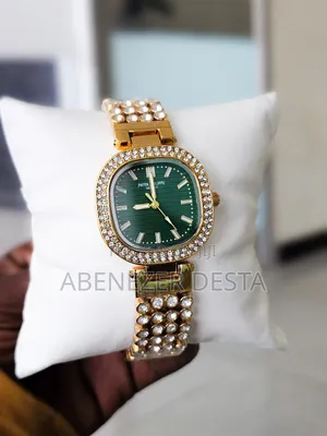 Gold-Plated Zircon Wrist Watch With a Green Dial.
