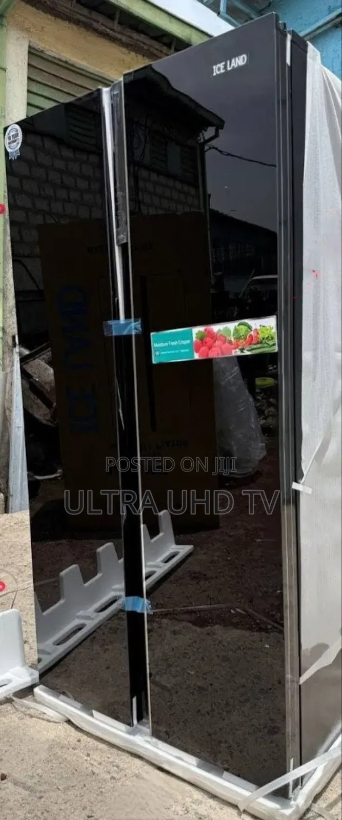 Ice Land Side-by-Side Refrigerator. It Has a Black Glass Finish And