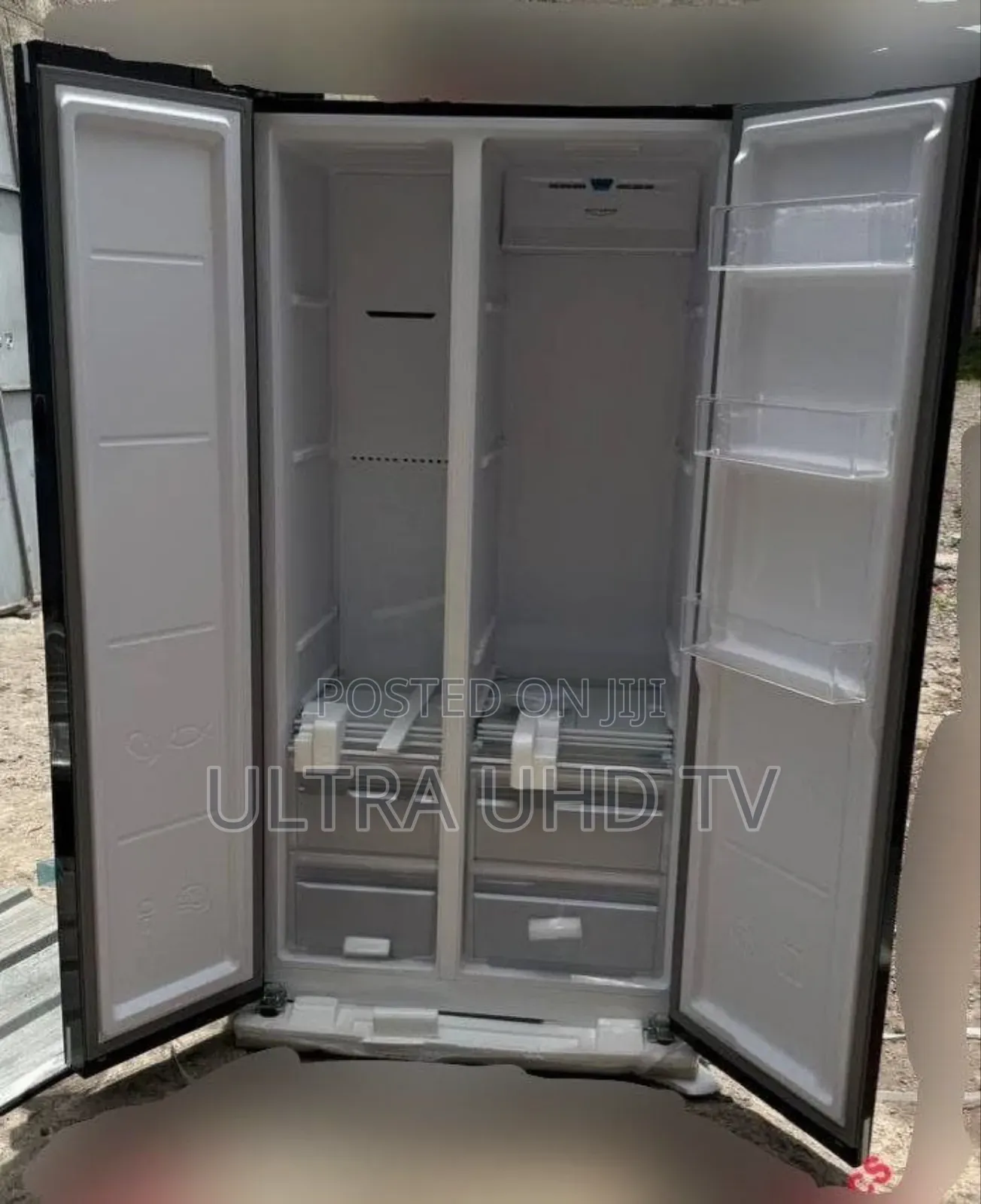 Ice Land Side-by-Side Refrigerator. It Has a Black Glass Finish And