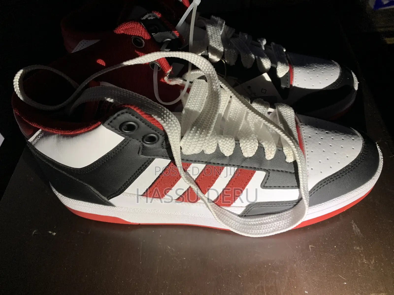 Adidas Rapid Court Mid Sneakers in a Black, White, and Red Colorway.
