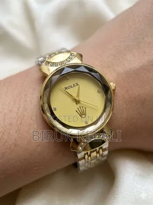 Gold-Toned Women's Watch Features a Black Dial, a Faceted Bezel
