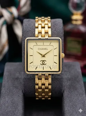 Chanel-Style Watch With a Gold-Tone Square Face and a Link Bracelet.