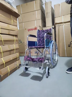 This Is a Foldable Children's Manual Wheelchair With a Patterned Seat