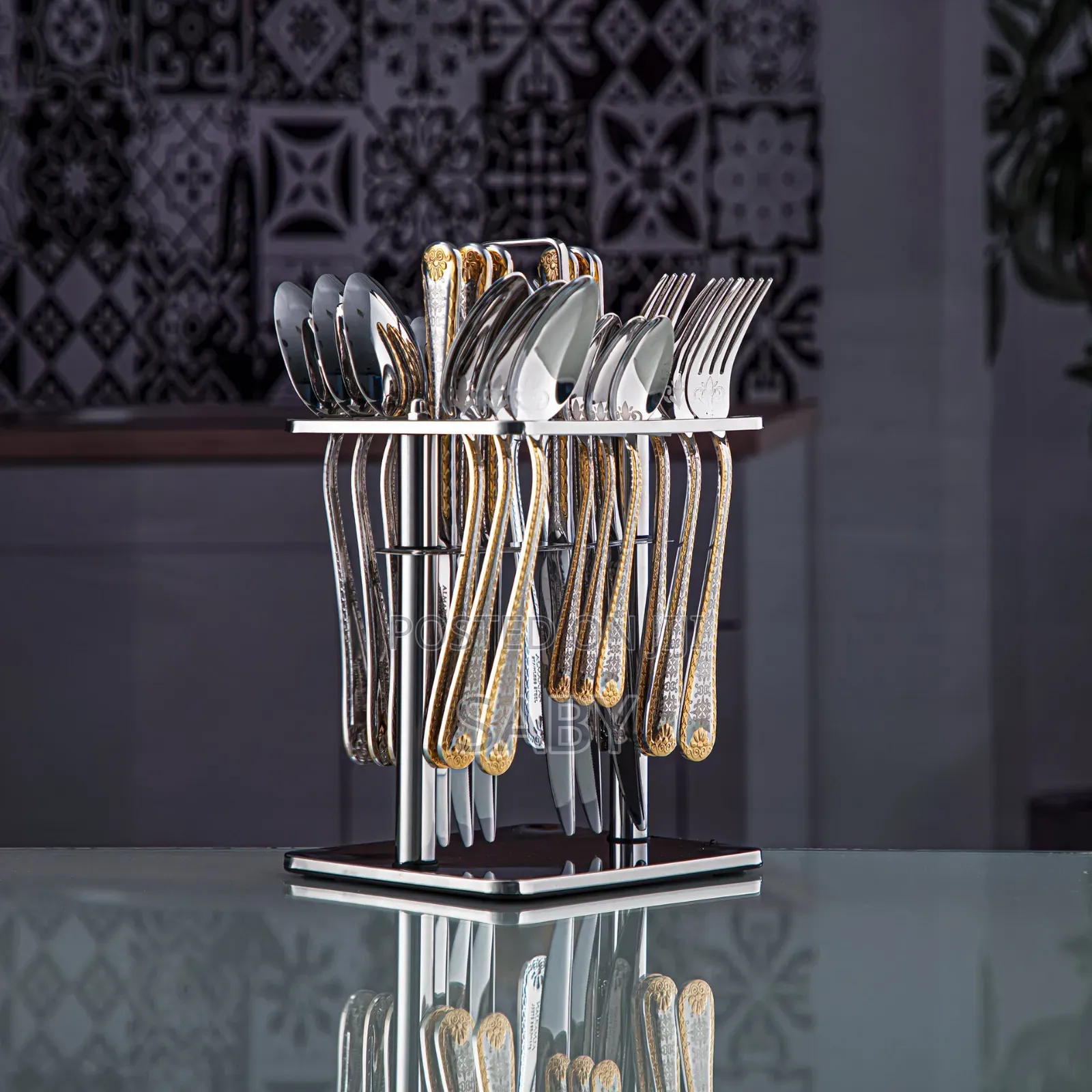 Stainless Steel 24-Piece Cutlery Set With a Gold-Accented Stand.