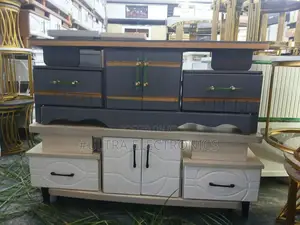 Tv Stand Featuring A White Lower Cabinet With A Textured Drawer Front
