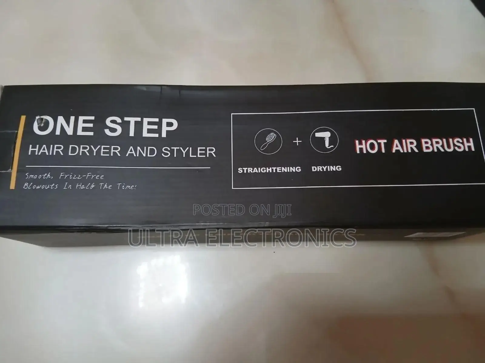 One Step Branded Hot Air Hair Dryer and Styler in a Black Box.