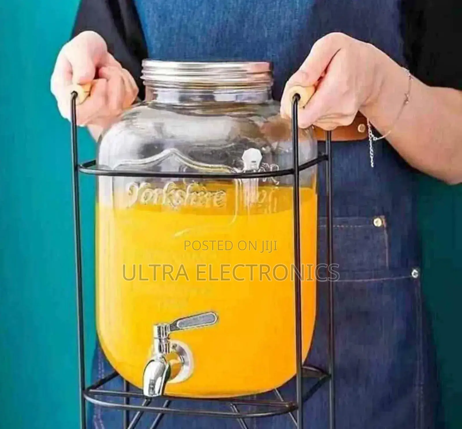 Yorkshire Branded Glass Beverage Dispenser With a Black Metal Stand.