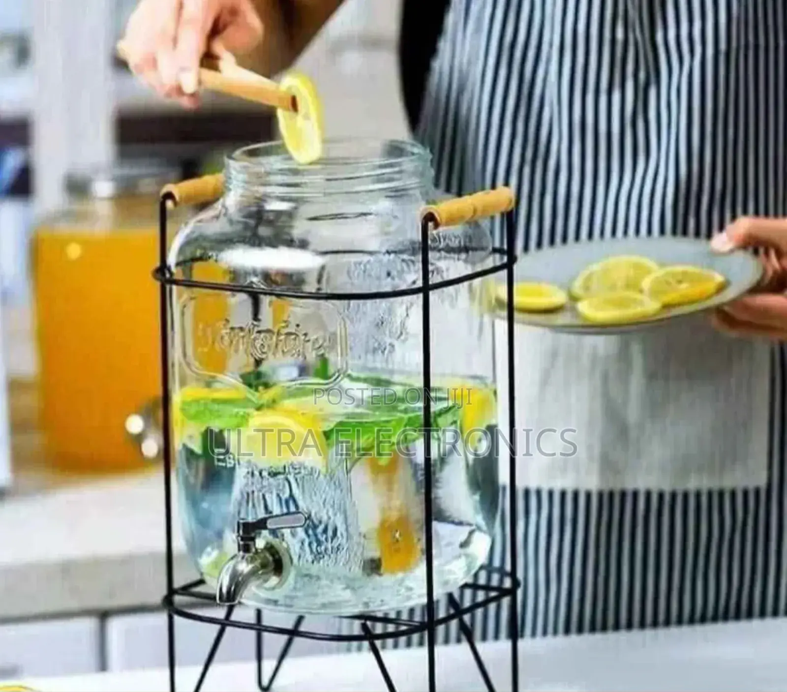 Yorkshire Branded Glass Beverage Dispenser With a Black Metal Stand.