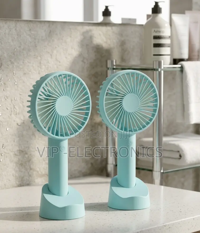 Twin Mint Green Handheld Fans on a Bathroom Vanity
