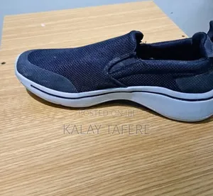 Black Skechers Men's Slip-on Walking Sneakers.