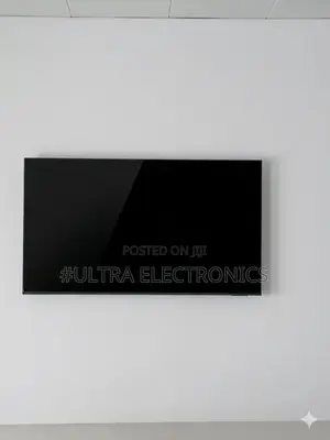 Samsung Qled 65 Inch Television Mounted on a Textured, Grey Stone