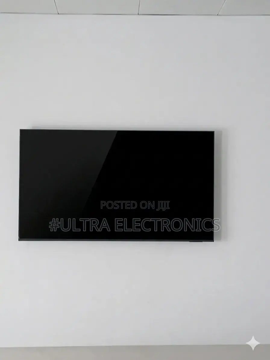 Samsung Qled 65 Inch Television Mounted on a Textured, Grey Stone