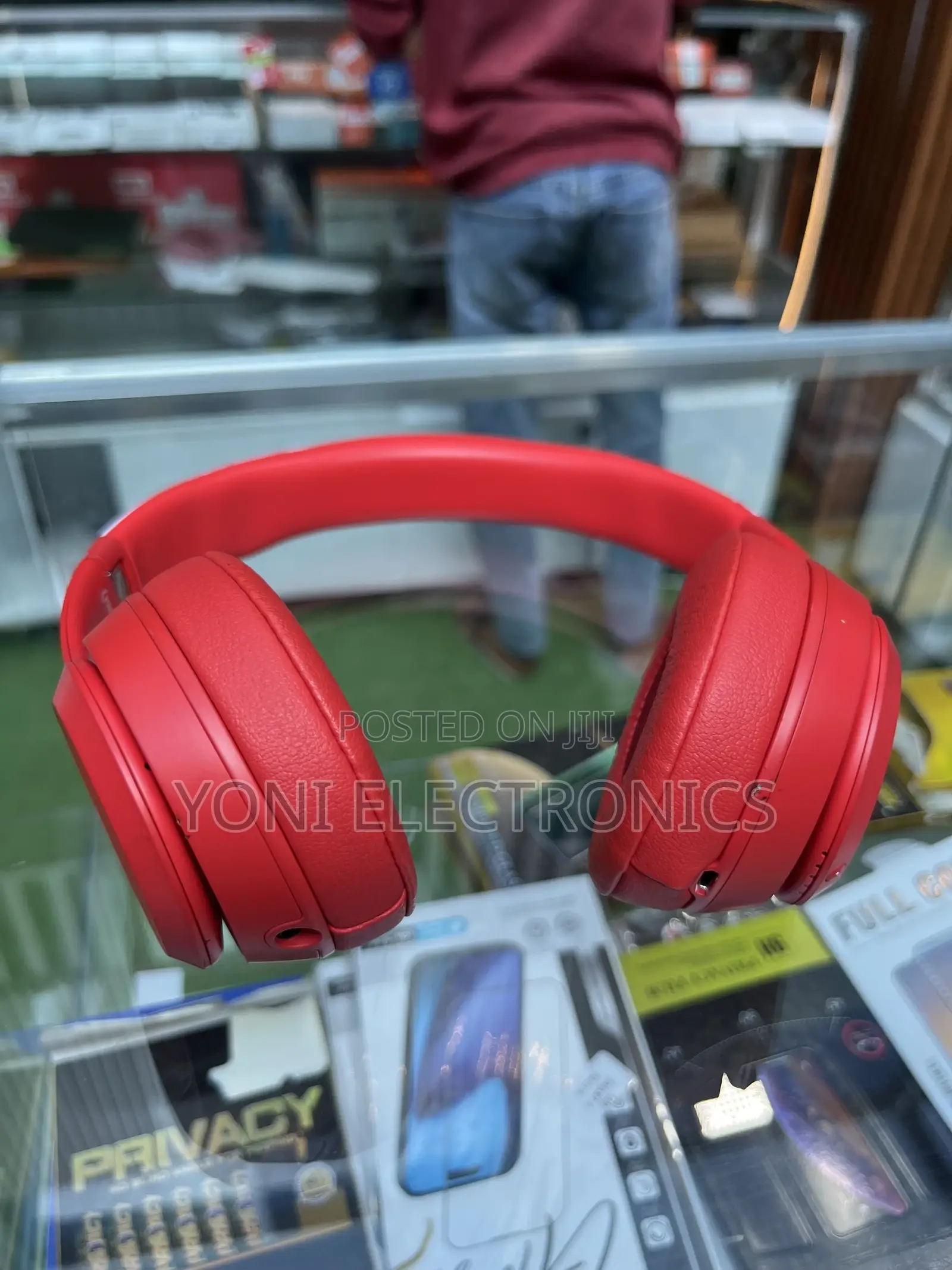 Hand Holding Red Beats Solo Headphones