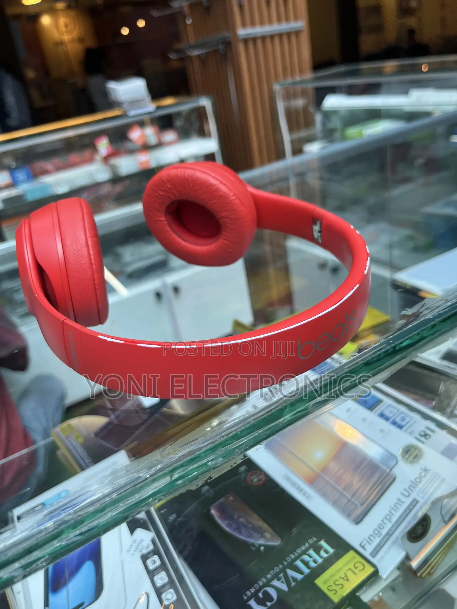 Hand Holding Red Beats Solo Headphones