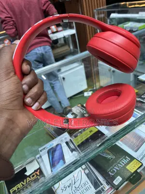 Hand Holding Red Beats Solo Headphones