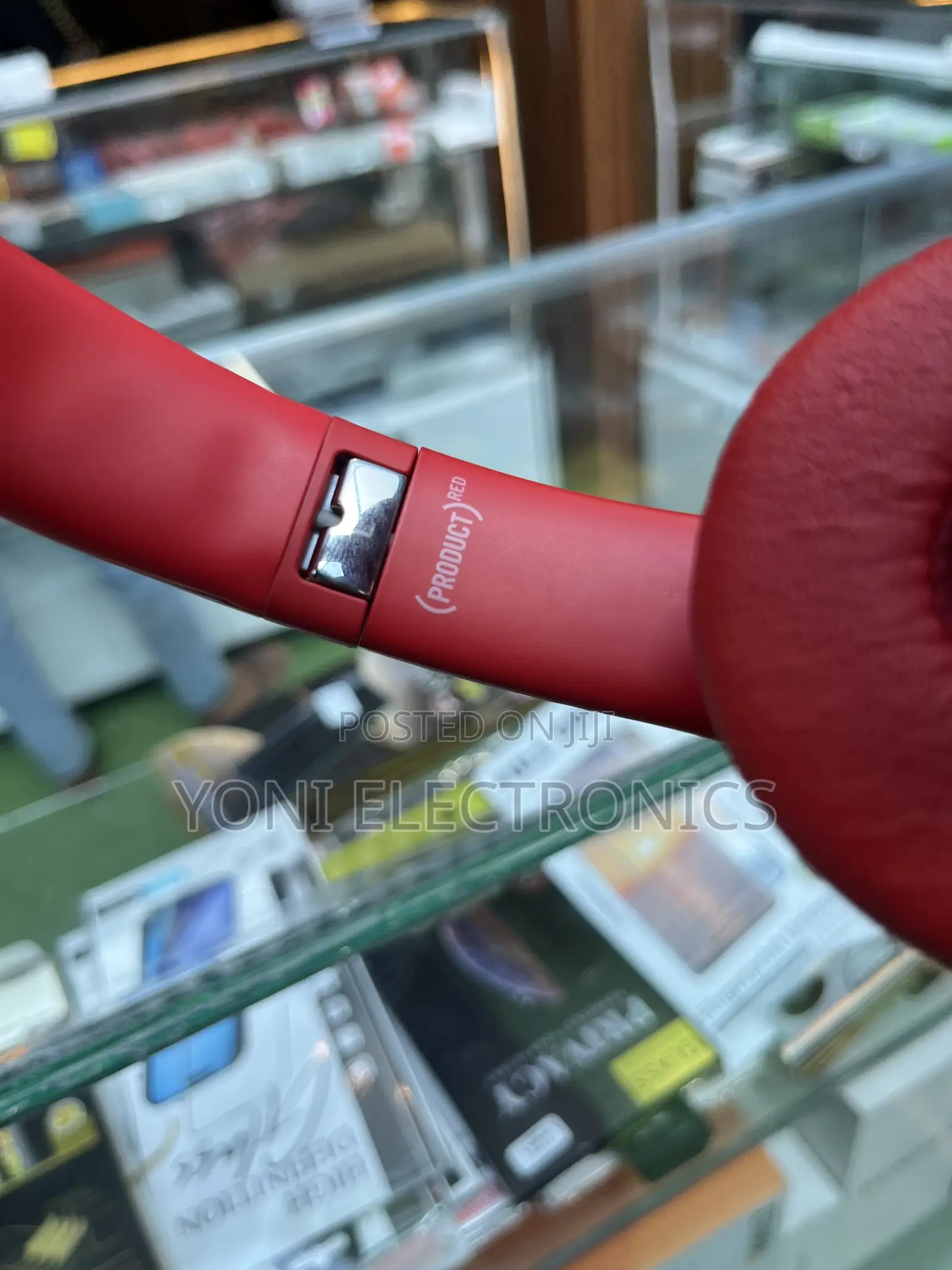 Hand Holding Red Beats Solo Headphones