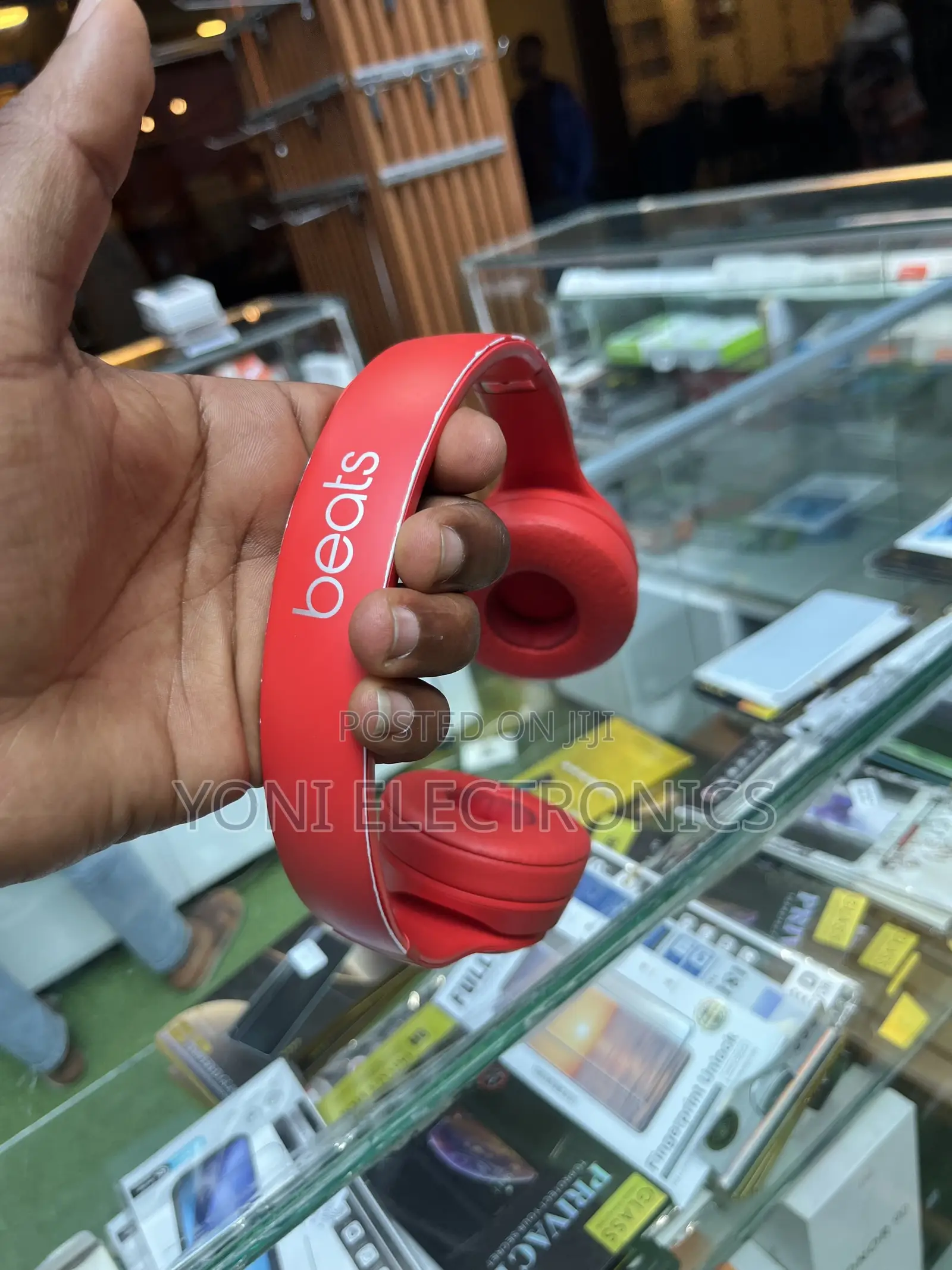 Hand Holding Red Beats Solo Headphones