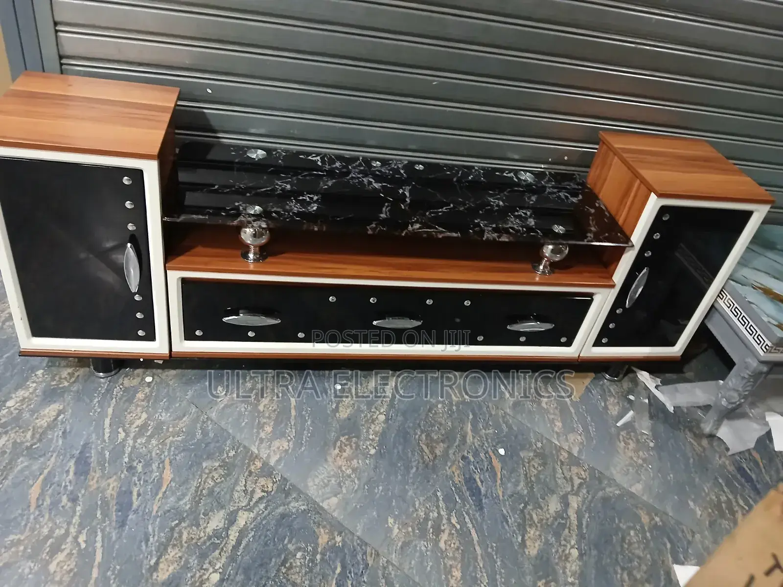 Tv Stand Features A Striking Black Marble-patterned Glass Top