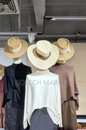 Featuring a Cream-Colored Batwing Poncho Top and Brown Knit Sweater.