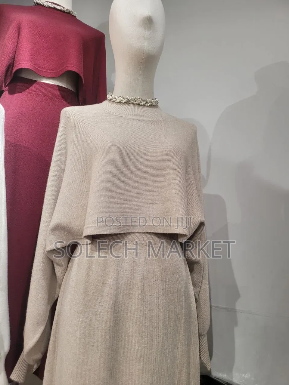 Featuring a Cream-Colored Batwing Poncho Top and Brown Knit Sweater.