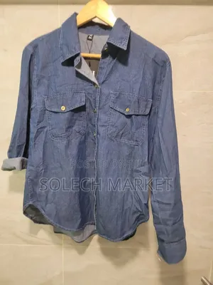 Light Blue Oversized Denim Shirt Features a Front Button Closure