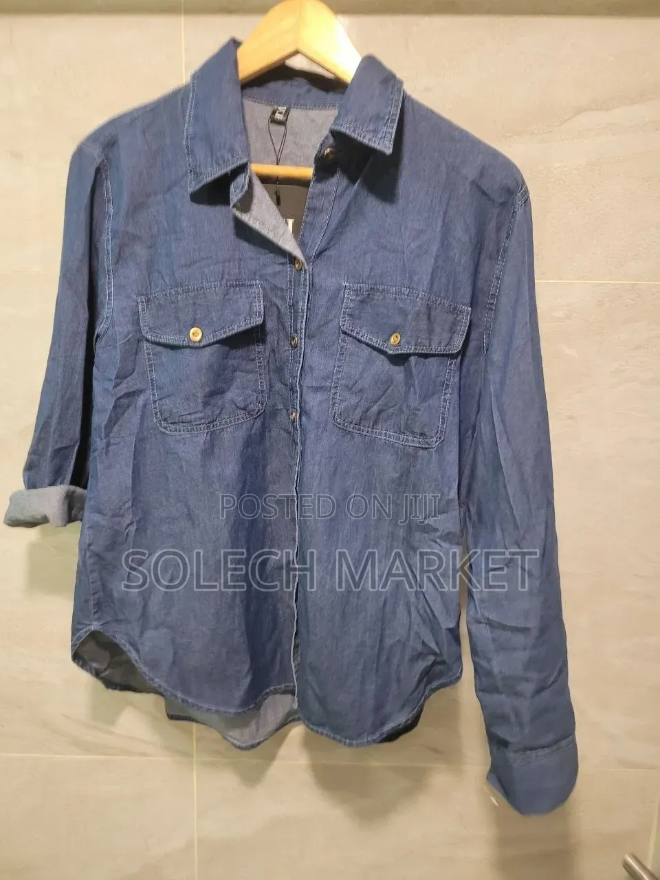 Light Blue Oversized Denim Shirt Features a Front Button Closure