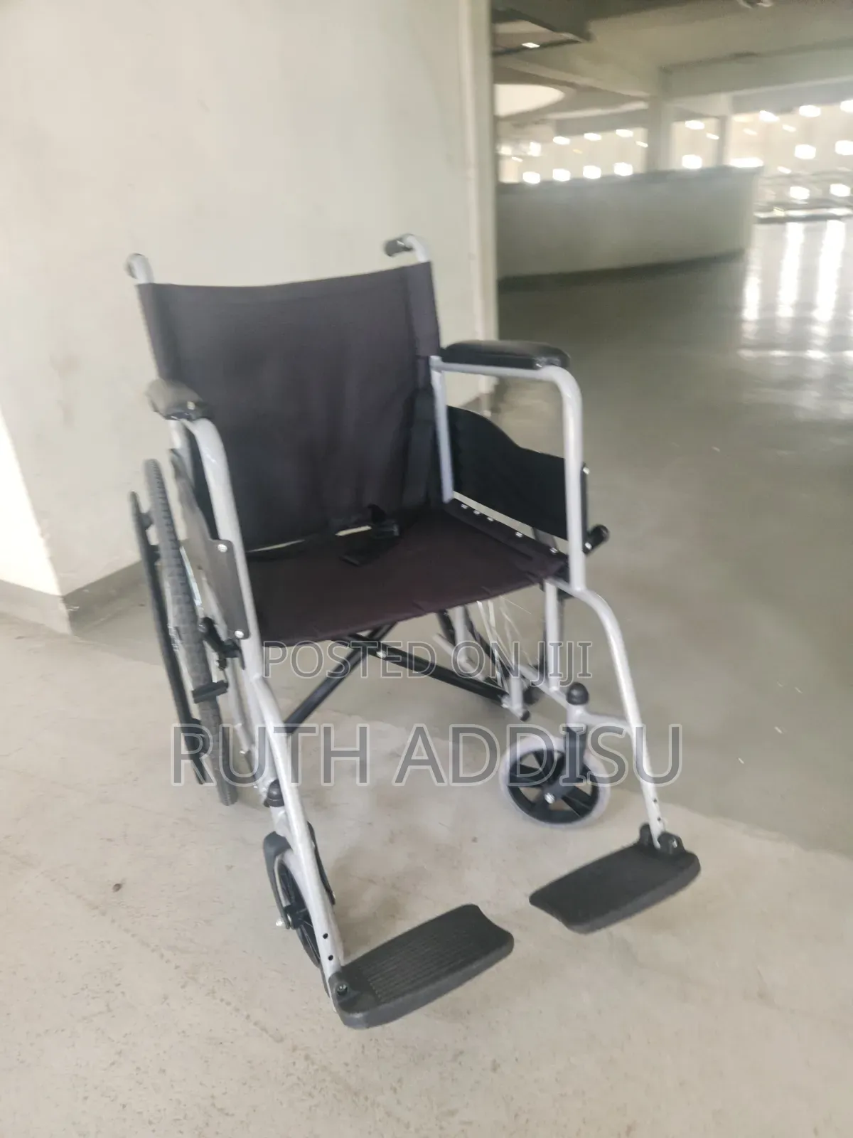 Manual Wheelchair Features a Lightweight Silver Frame and Durable Blac