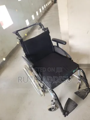 Breezy Rub Wheelchair Features a Black Seat and Folding Aluminum Frame