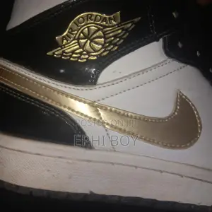 Nike Air Jordan 1 Mid in a Black/White/Metallic Gold