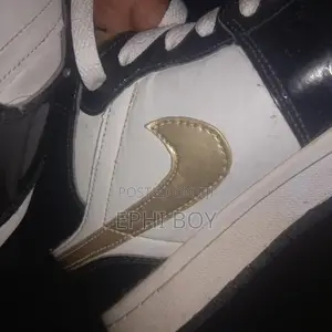 Nike Air Jordan 1 Mid in a Black/White/Metallic Gold