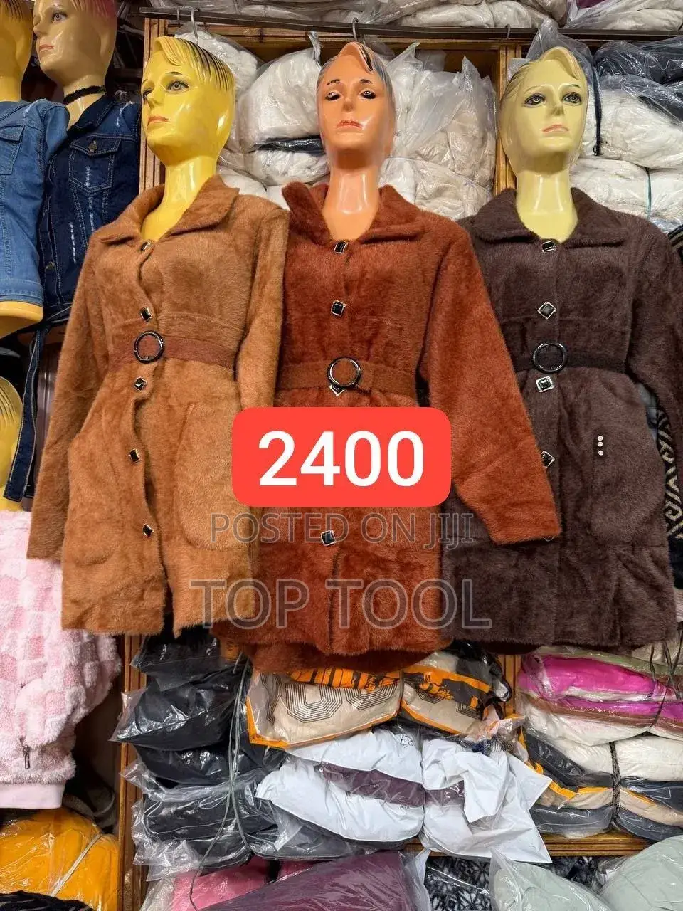 ፡ቡናማ የሰው ሰራሽ ፀጉር ኮት ሲሆን፣ ወገብን የሚያጠብቅ ቀበቶ እና የፊት በአዝራር መዝጊያ አለው።