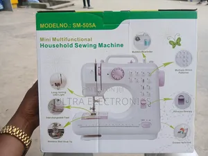 Mini Multifunctional Household Sewing Machine in Its Product Box.
