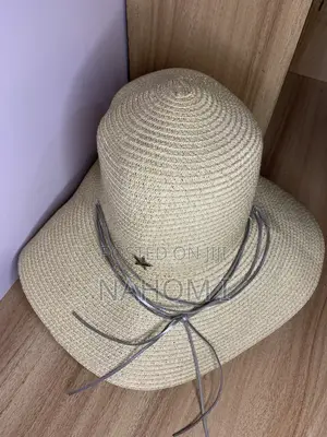 HAT Woven Paper Straw Wide-Brim Hat Features a Distinctive Silver Star
