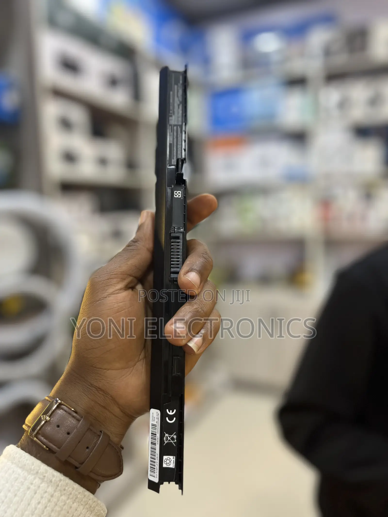 Person Holding a Slim Laptop Battery Replacement