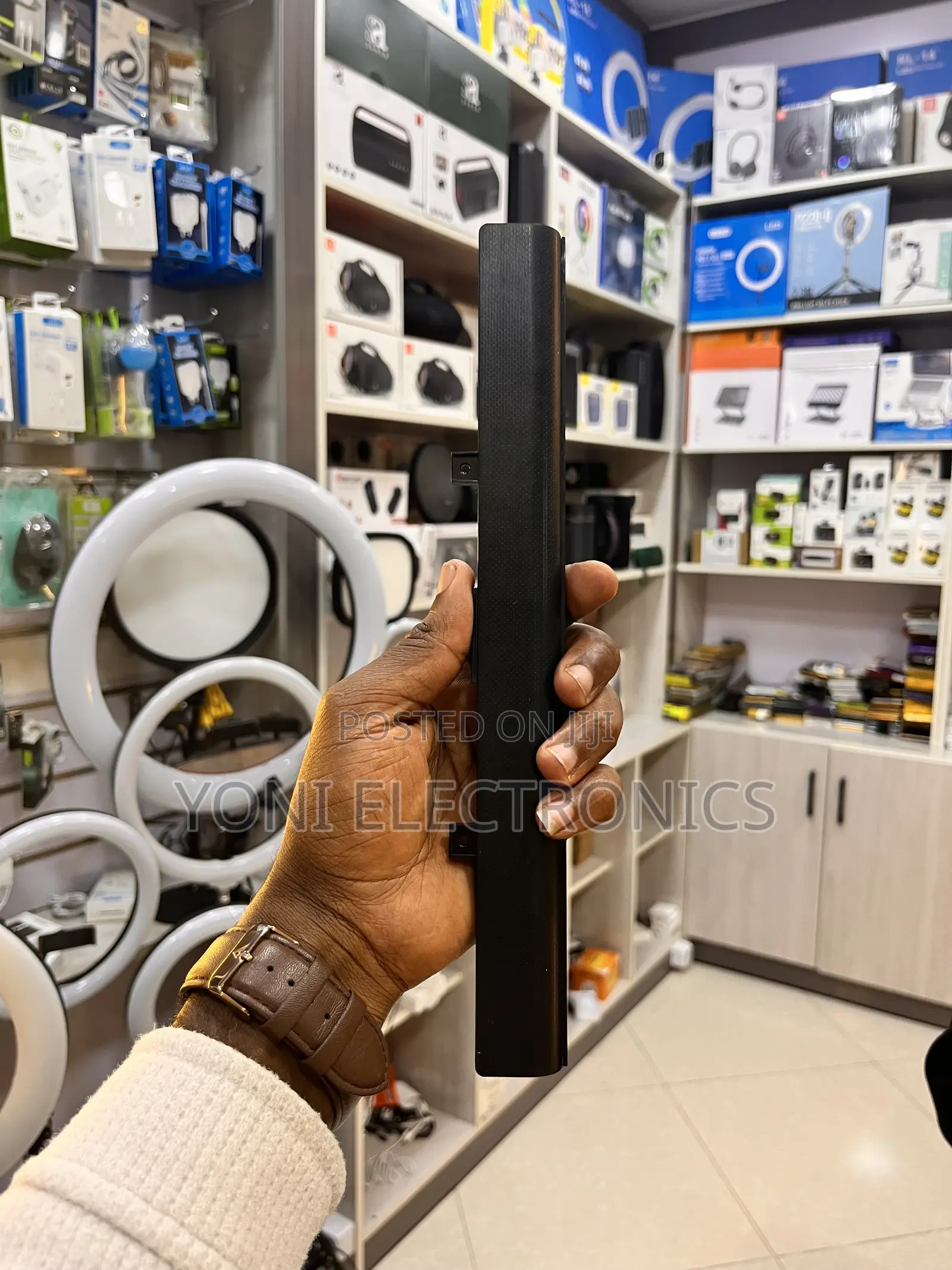 Person Holding a Slim Laptop Battery Replacement