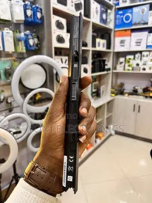 Person Holding a Slim Laptop Battery Replacement