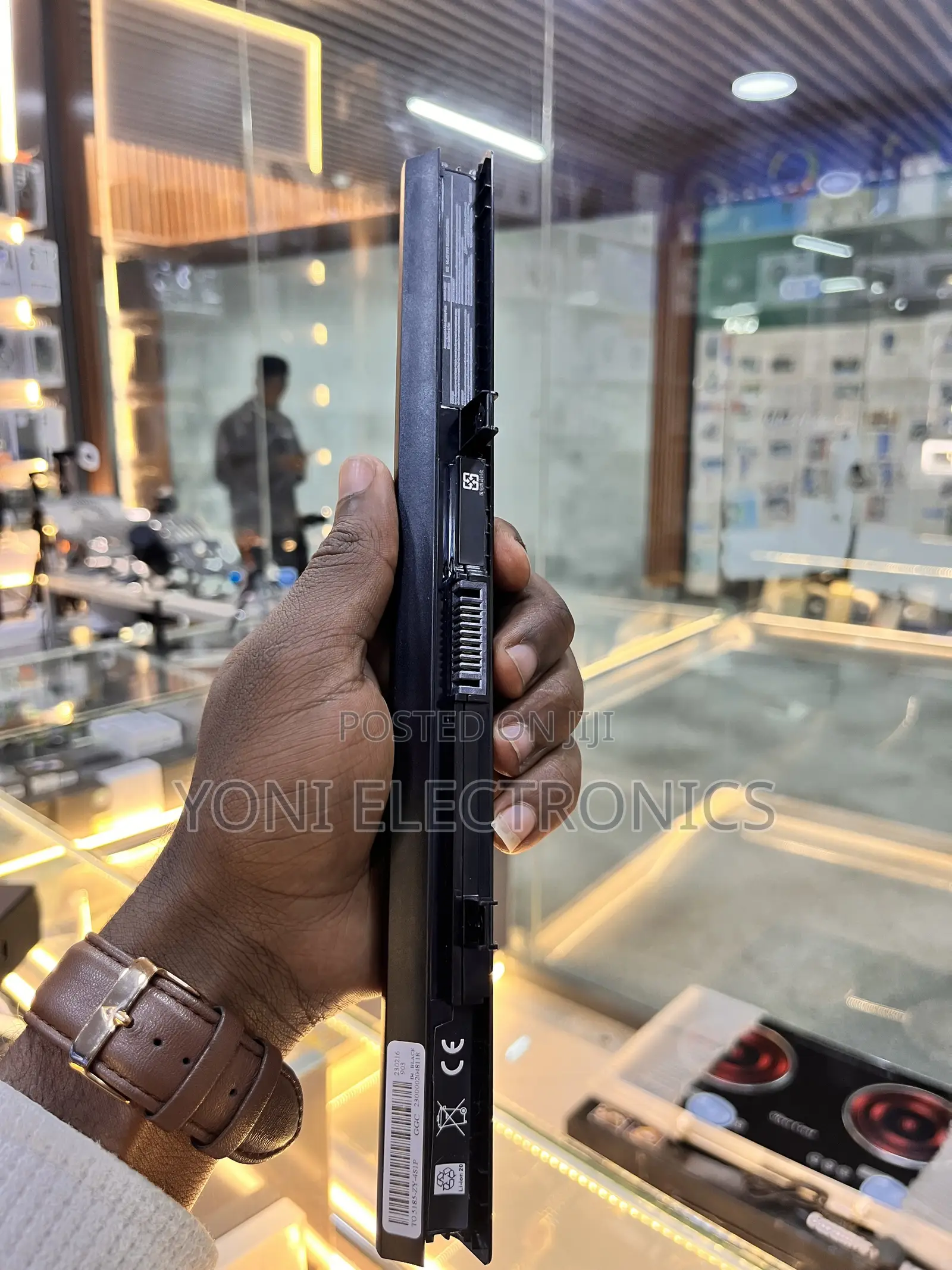 Person Holding a Slim Laptop Battery Replacement
