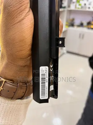 Person Holding a Slim Laptop Battery Replacement