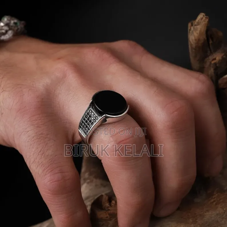 Sterling Silver Ring Featuring a Black Onyx Stone and Smaller Black