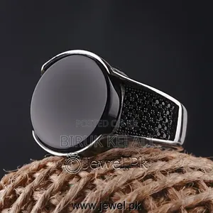 Sterling Silver Ring Featuring a Black Onyx Stone and Smaller Black
