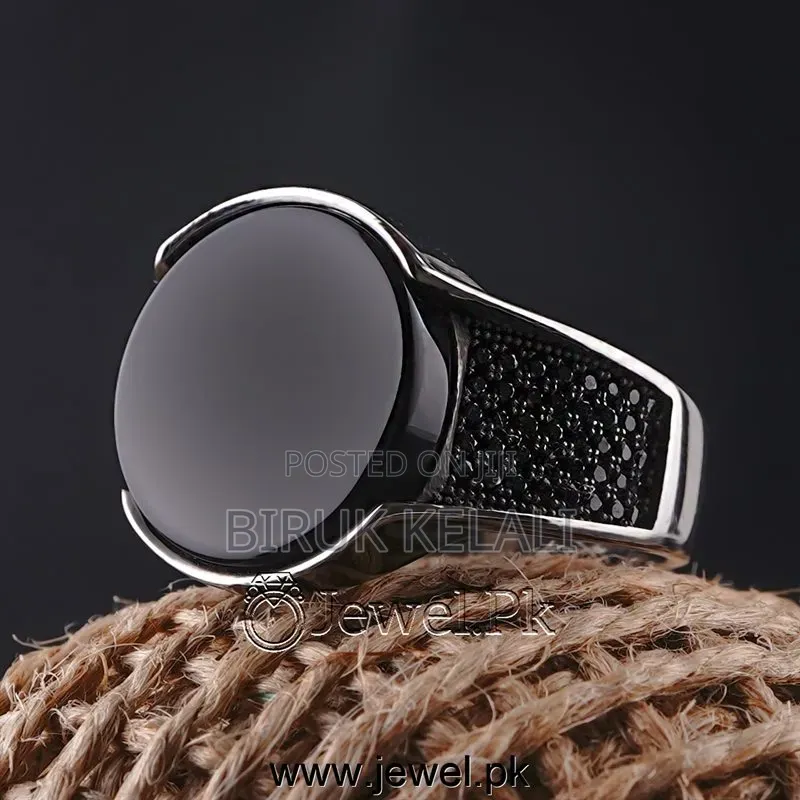 Sterling Silver Ring Featuring a Black Onyx Stone and Smaller Black