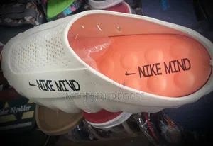 Nike Mind 001 Slip-on Mules in a White and Orange Colorway
