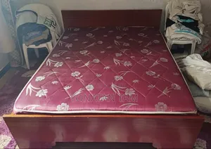 Bed Along With It's Matress and a Night Stand