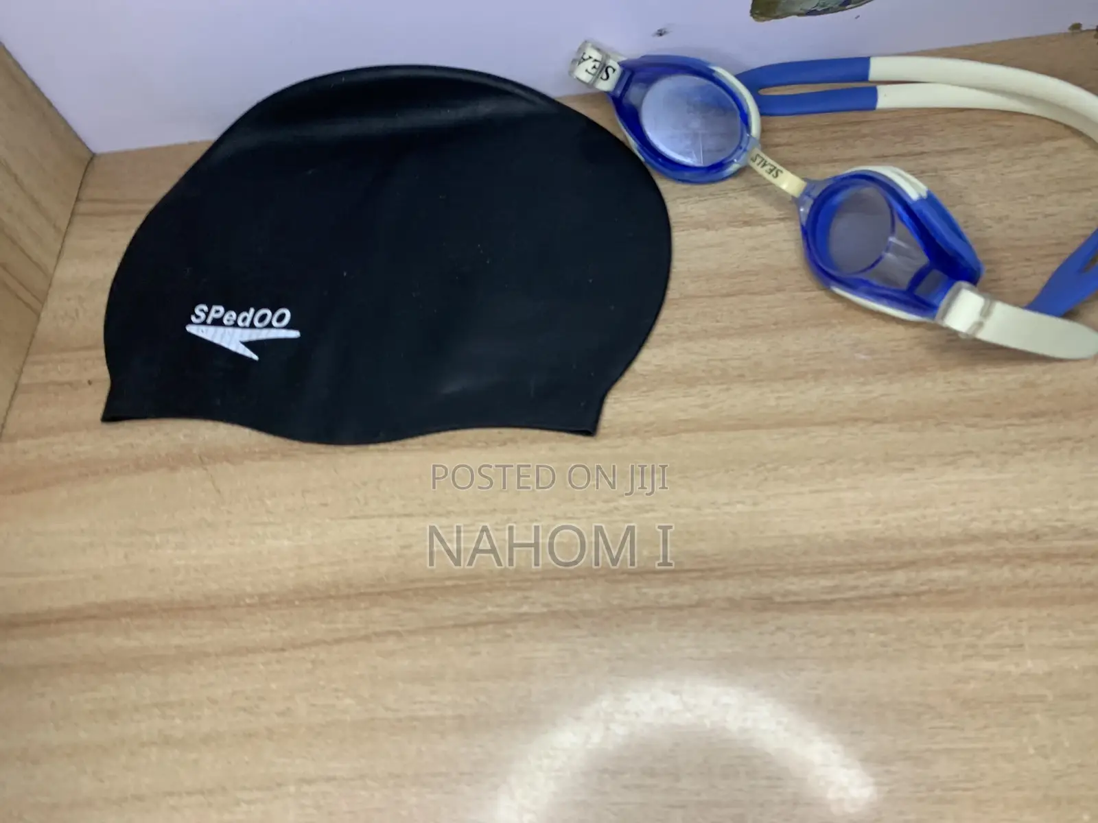 A Black Speedo Swim Cap Alongside Blue-and-White Speedo Jet Swimming