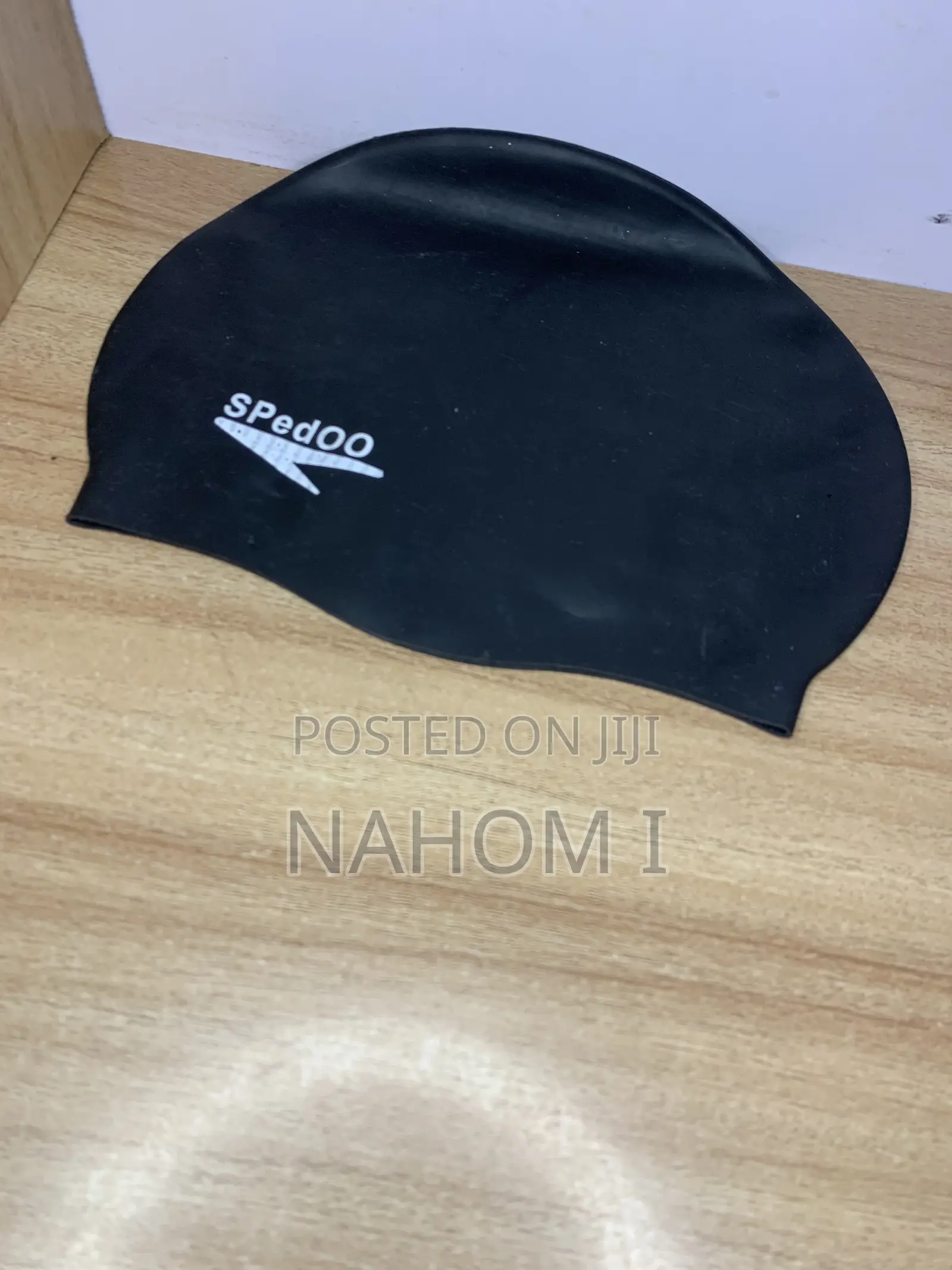 A Black Speedo Swim Cap Alongside Blue-and-White Speedo Jet Swimming